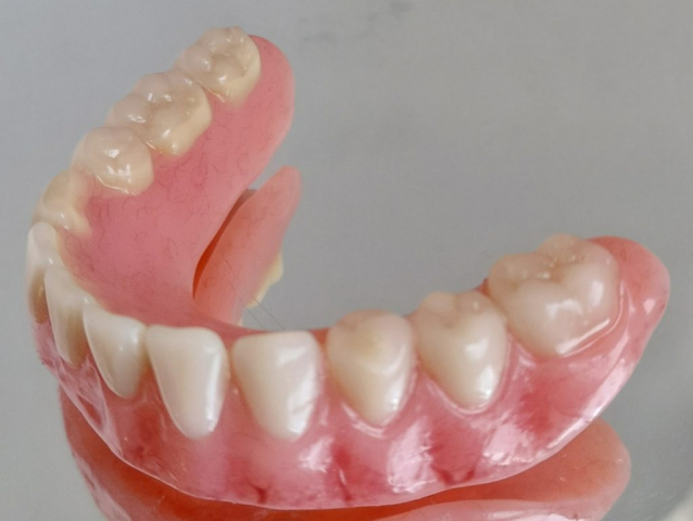 Lower denture with gum staining